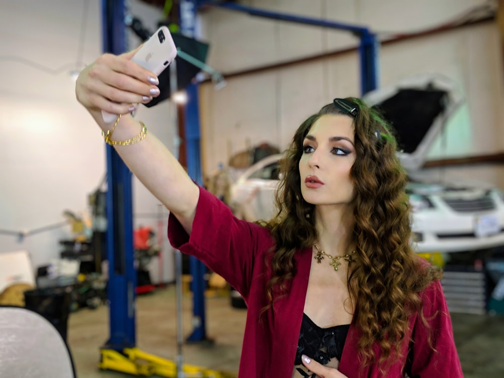 selective focus photo of woman taking selfie