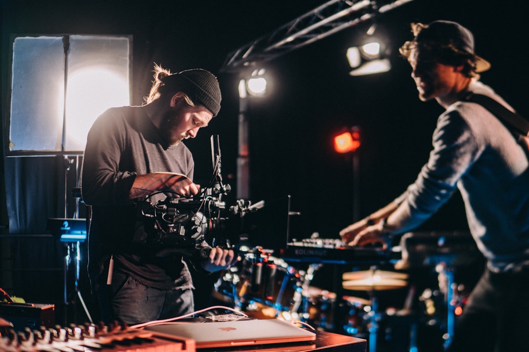 selective focus photo of man holding black camera