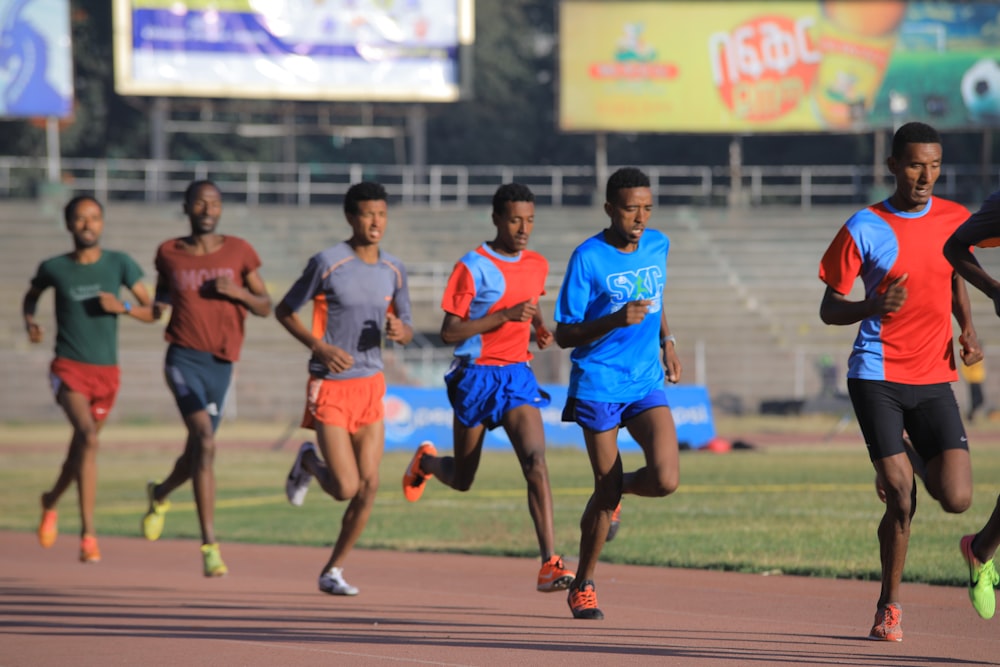 men running near bleachers