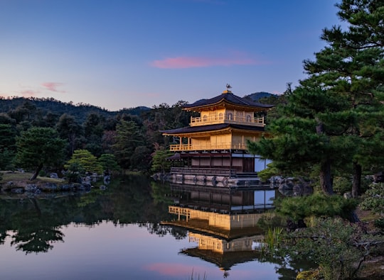 golden temple surrounded with body of water in Kinkaku-ji Japan
