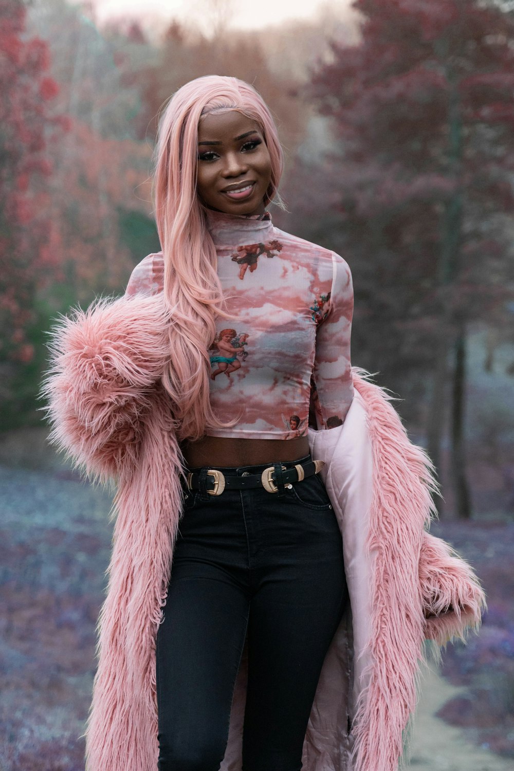 woman with pink hair wearing pink fur coat during daytime