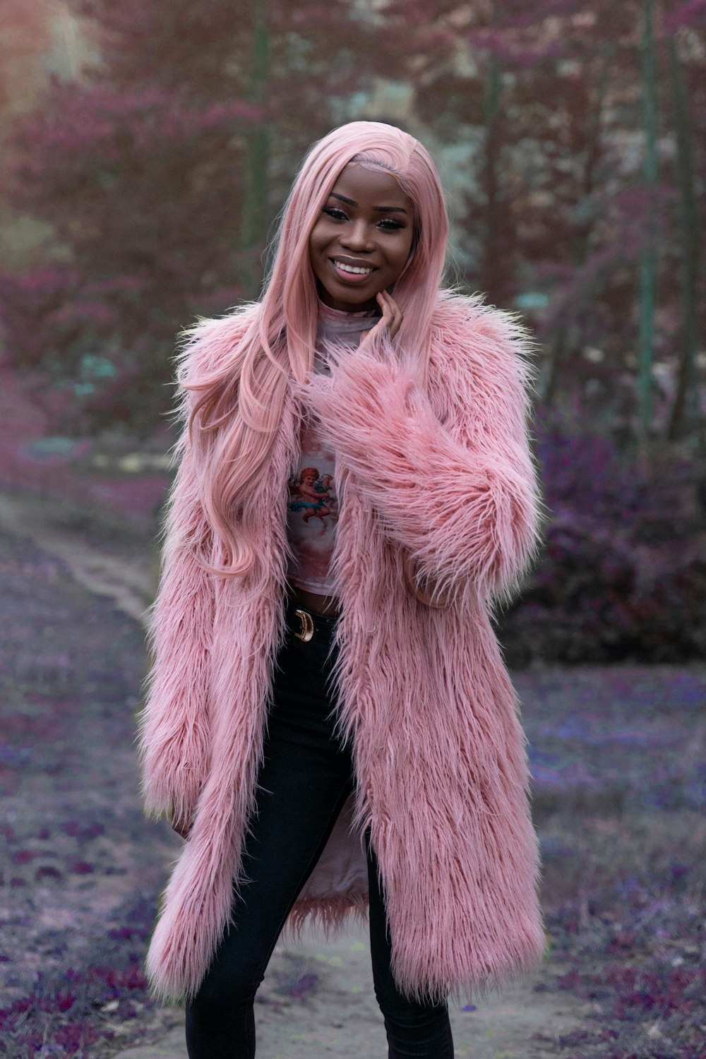 woman with pink hair wearing pink fur coat during daytime