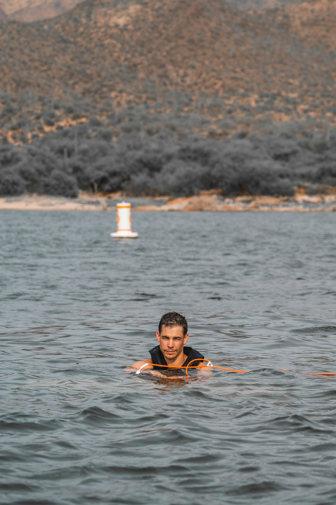 man swim in sea during daytime