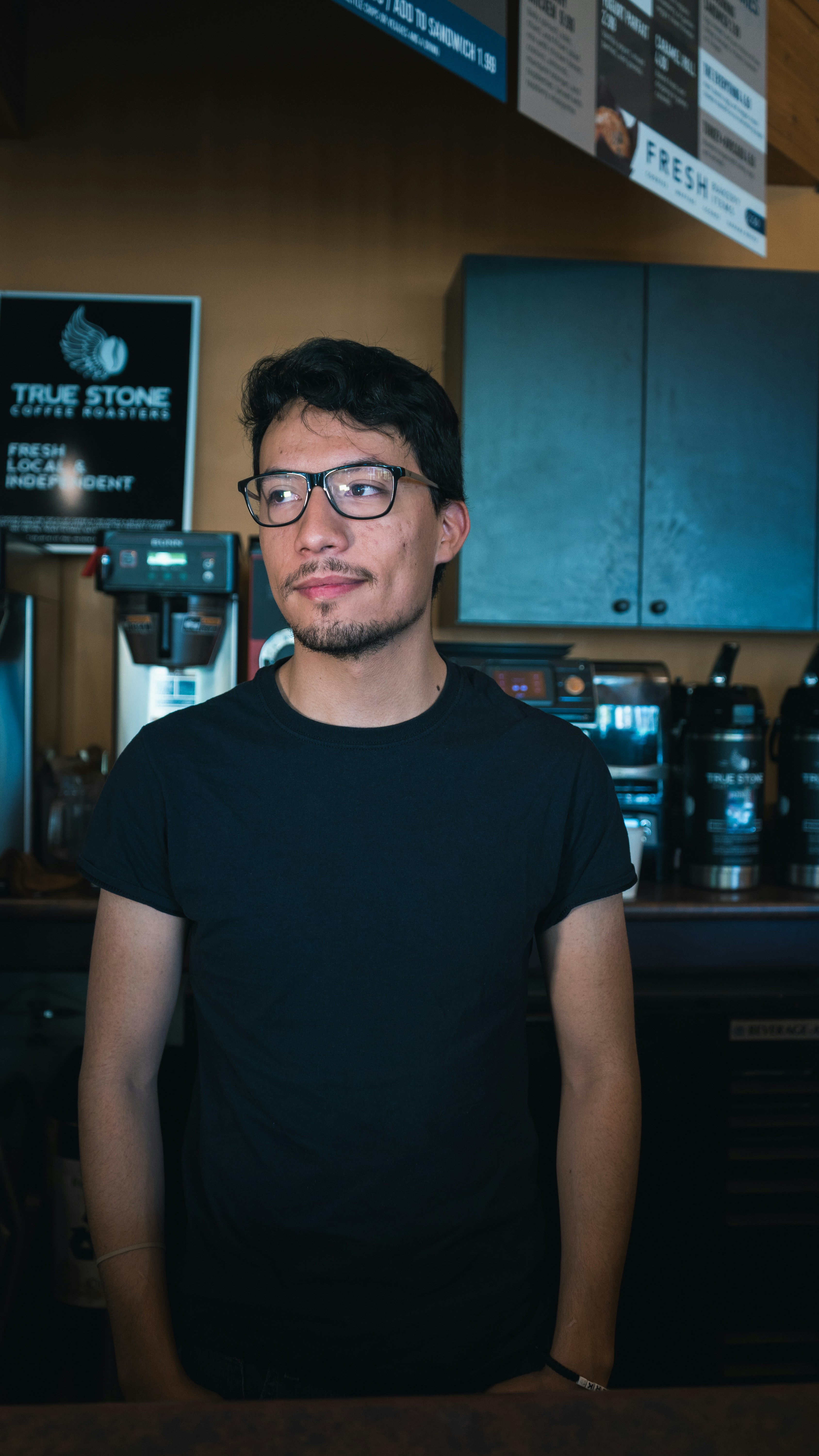 man standing near brown wall