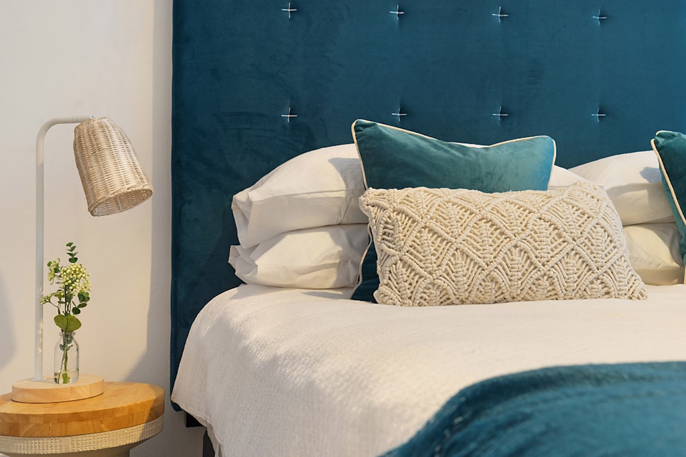 cama azul e colchão com travesseiros