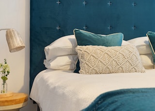 blue bed and mattress with pillows