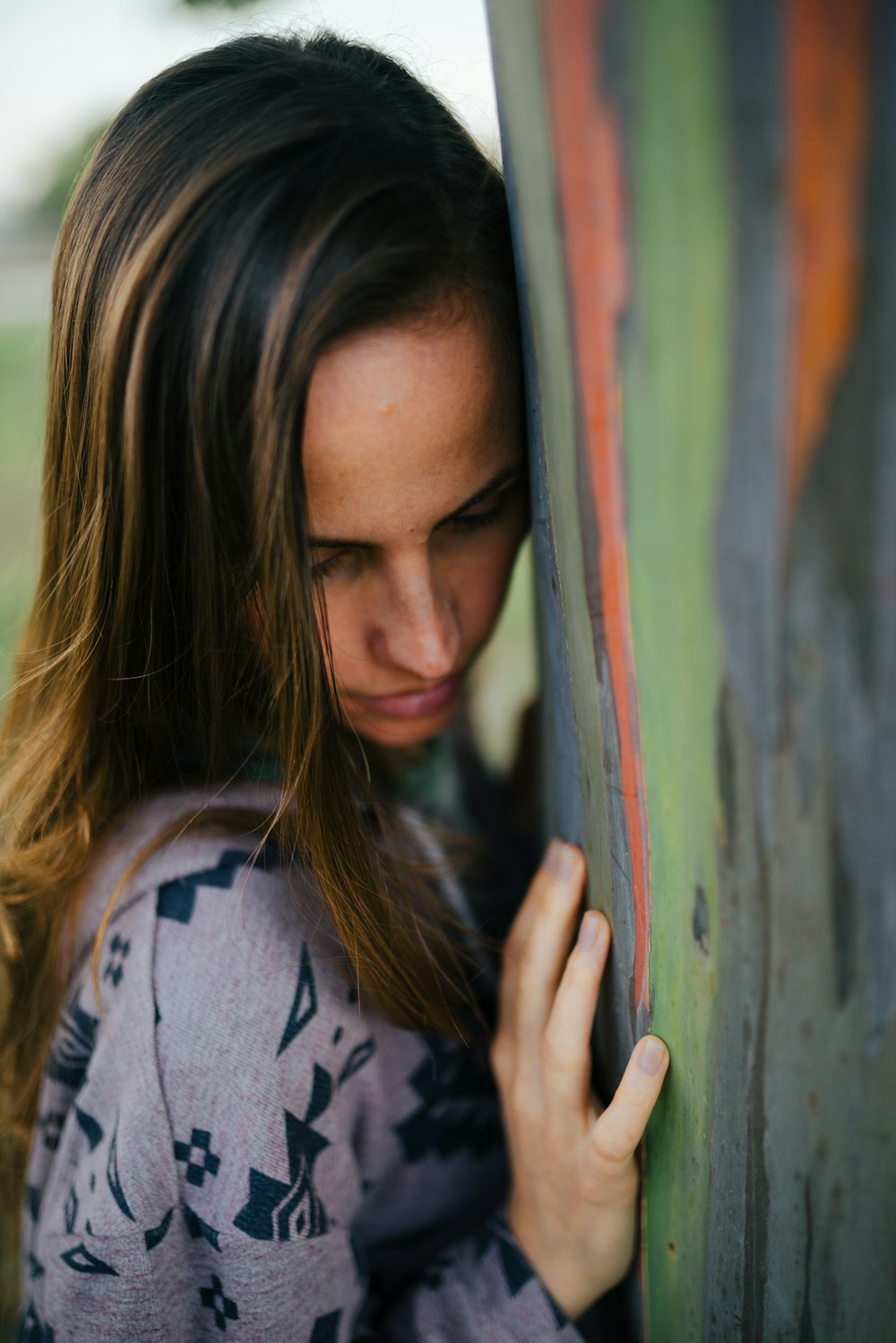 a woman leaning against a wall with her hand on the wall