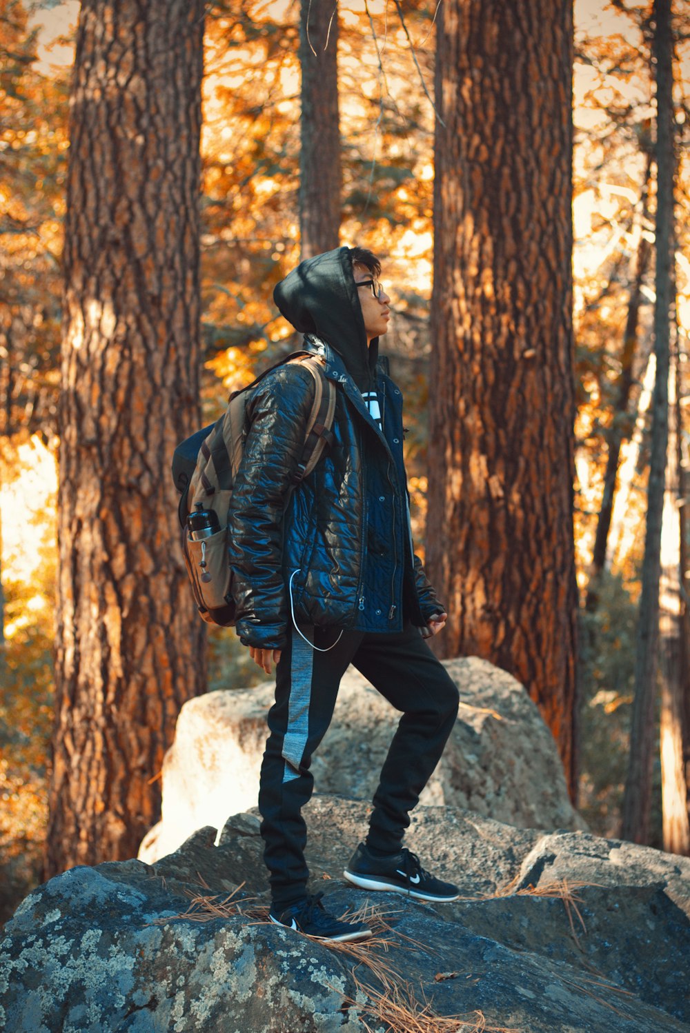 man standing on side near green trees