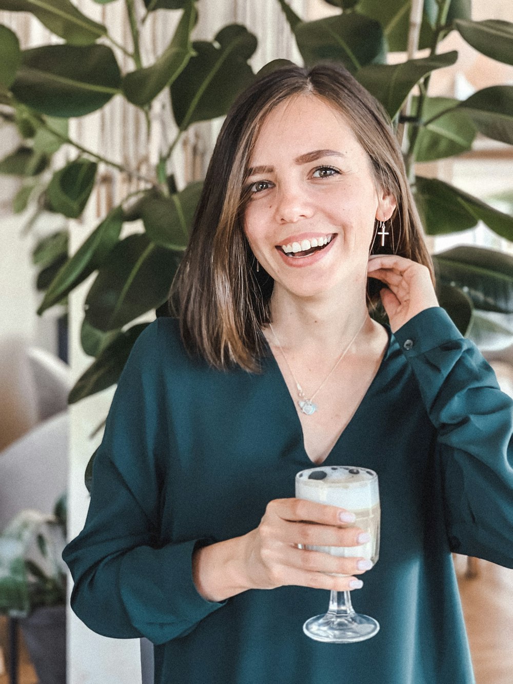 woman smiling and holding drink