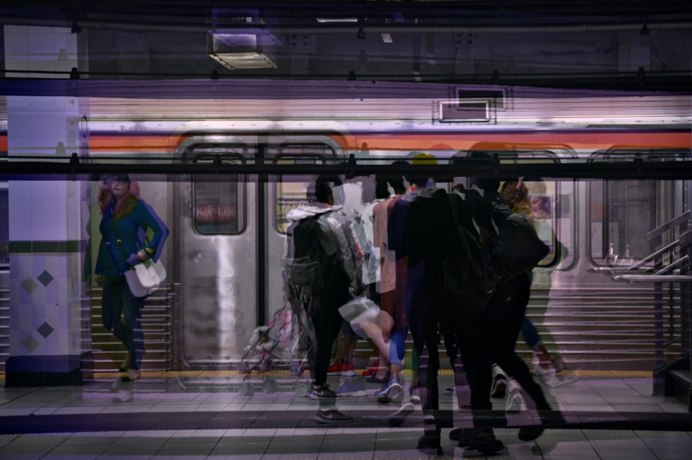 a group of people standing on a subway platform