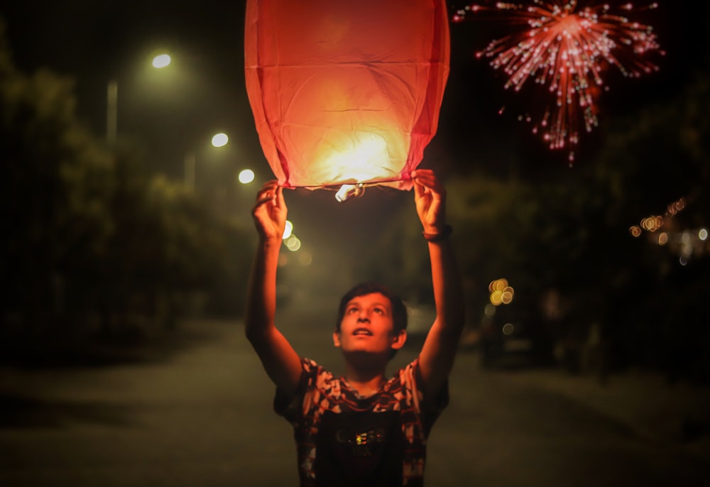 man holding sky lantern