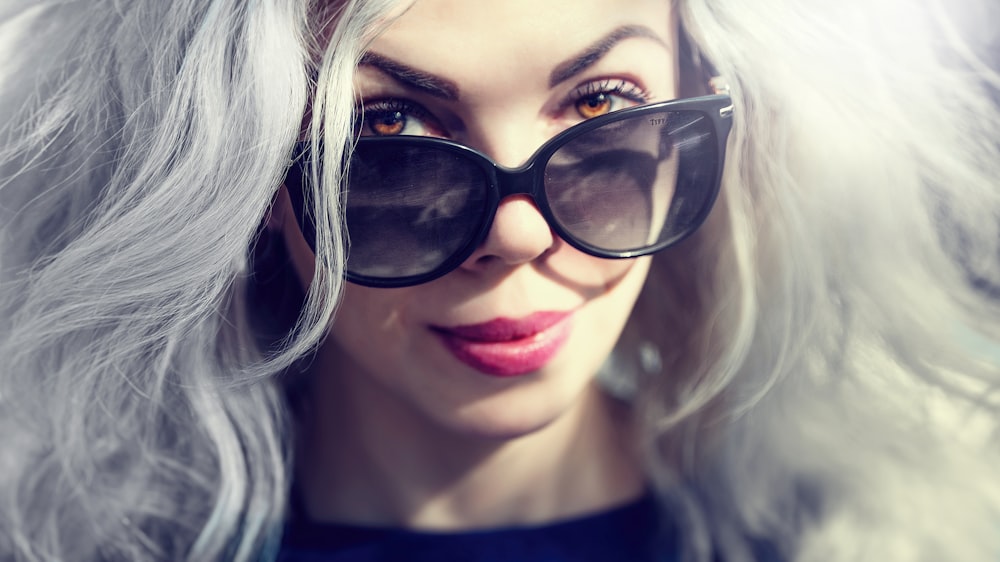 woman wearing black sunglasses taking selfie