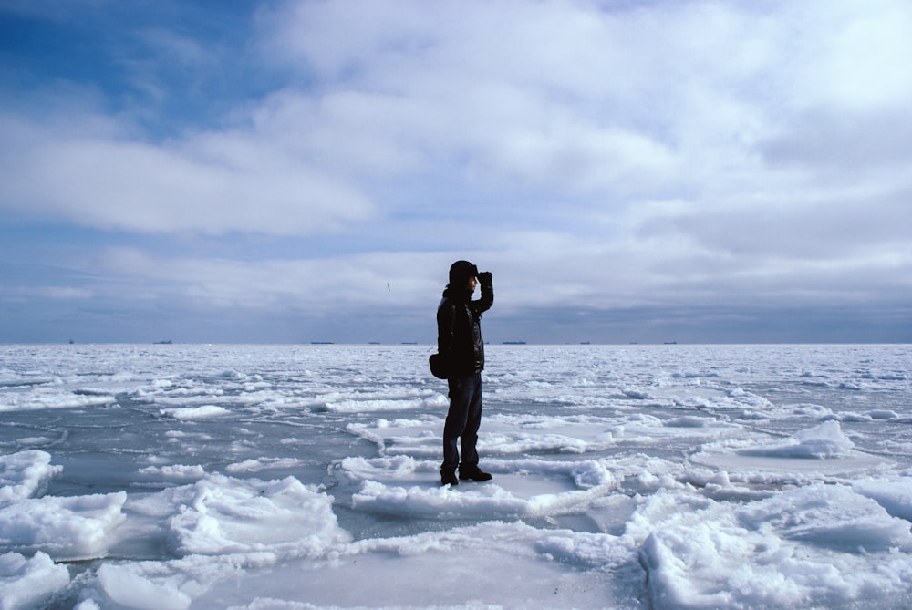 man standing on snowfield during day