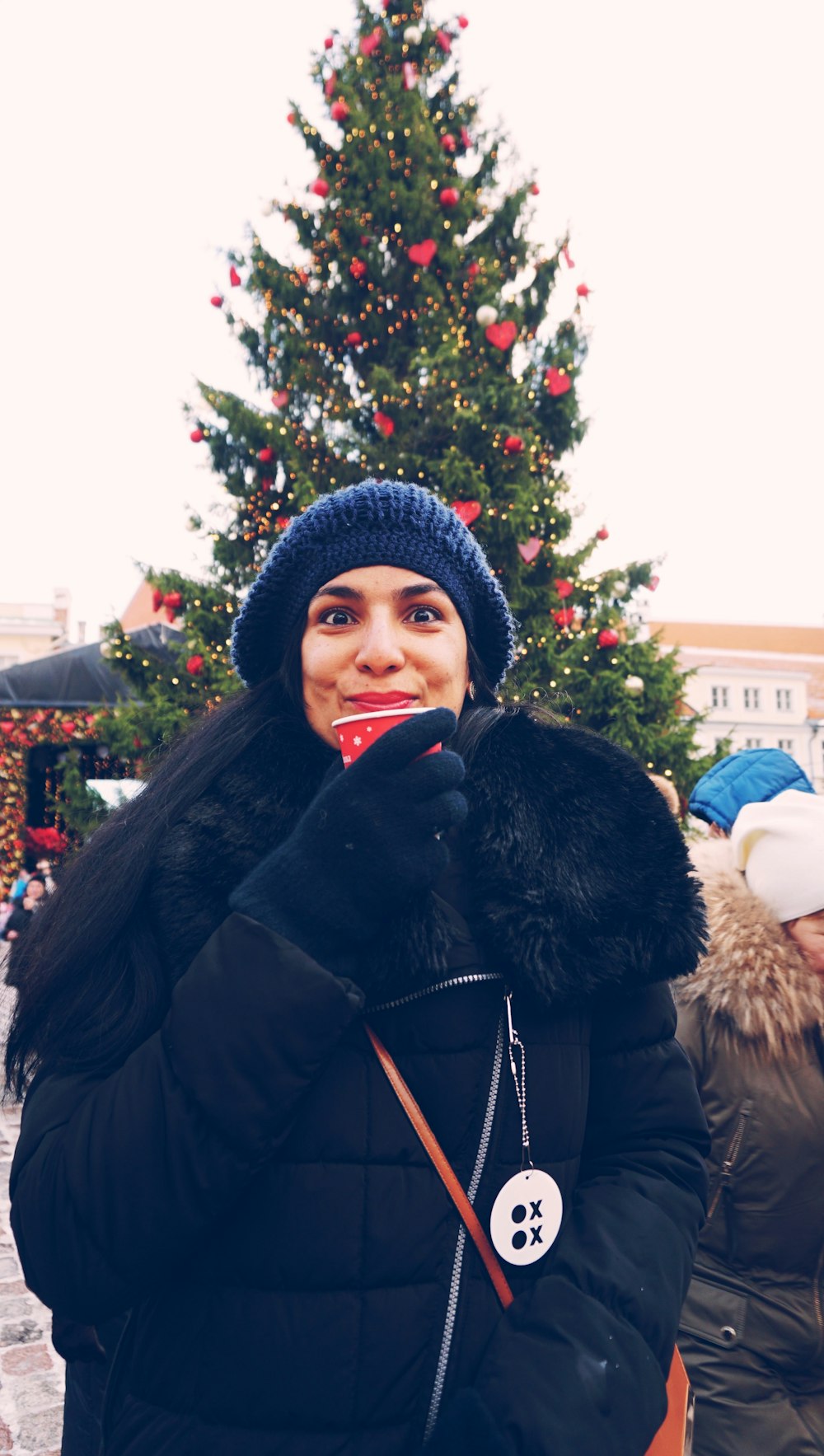 woman wearing black jacket and knit cap