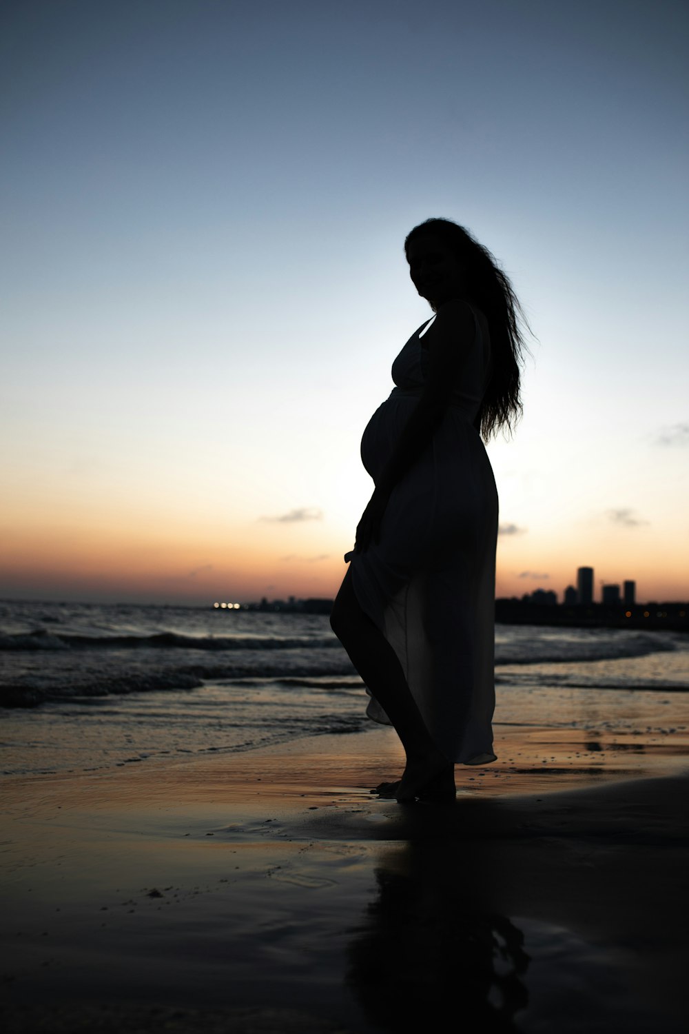 pregnant woman standing on shore