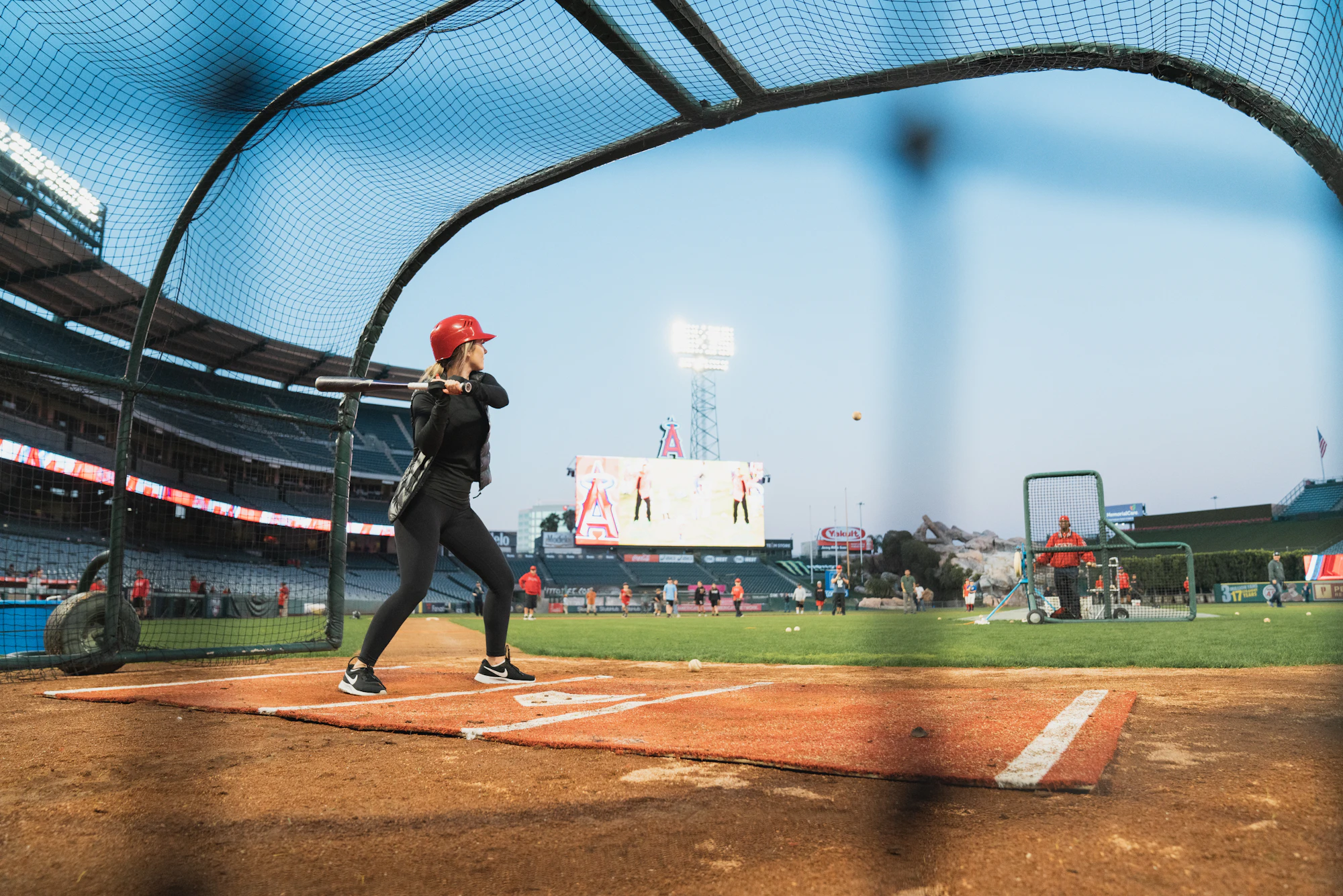 Batter mid-swing in a cage