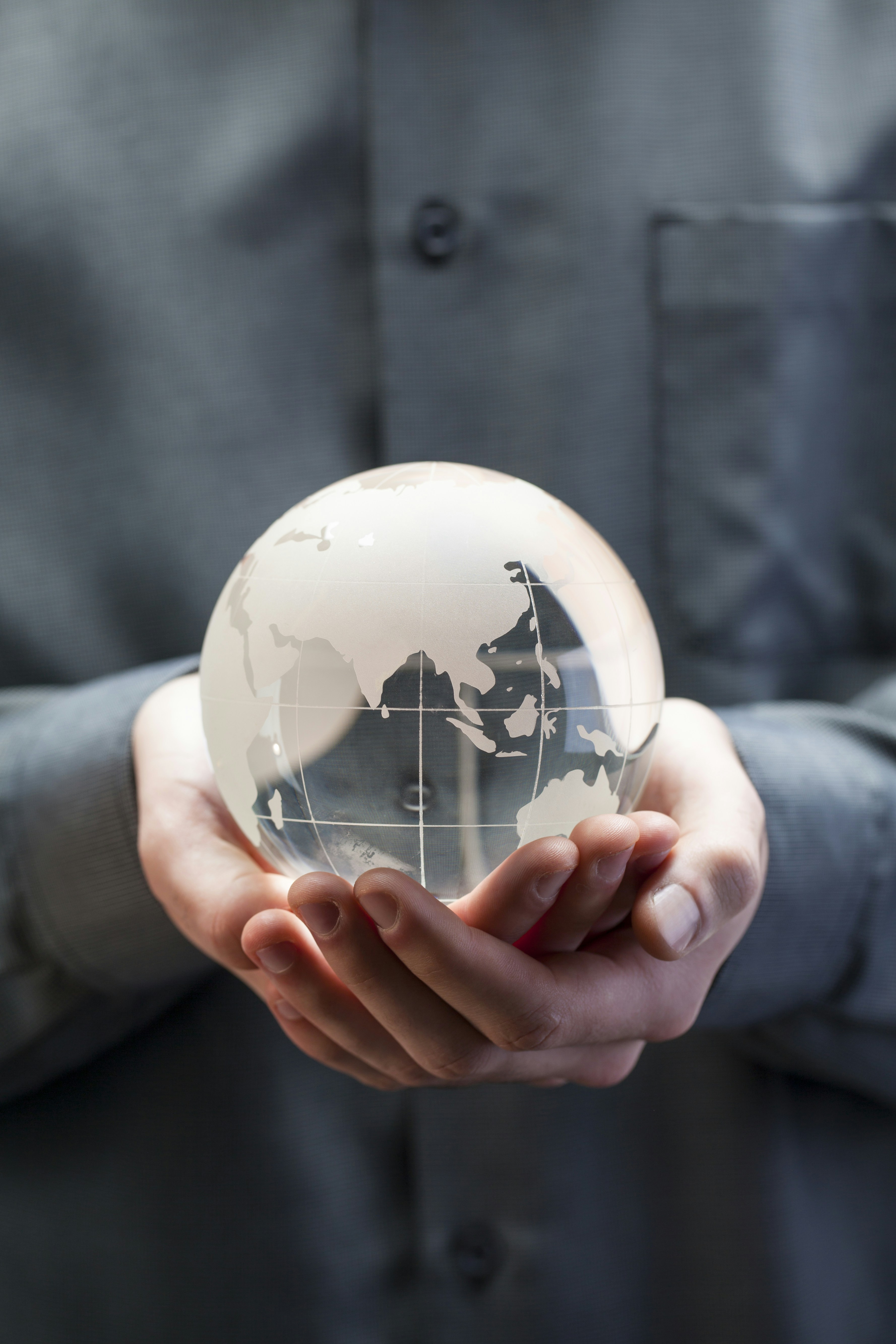 &quot;Man holding glass globe in hands. Concept for CHINA global warming, climate change, environmental protection.&quot;