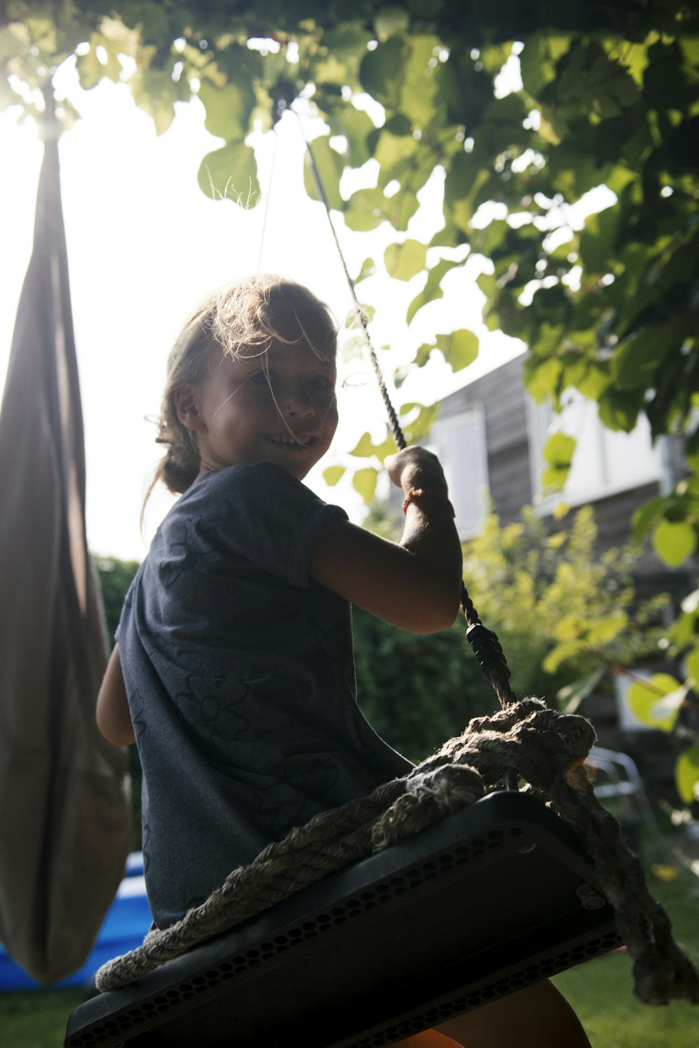 girl swings at the backyard