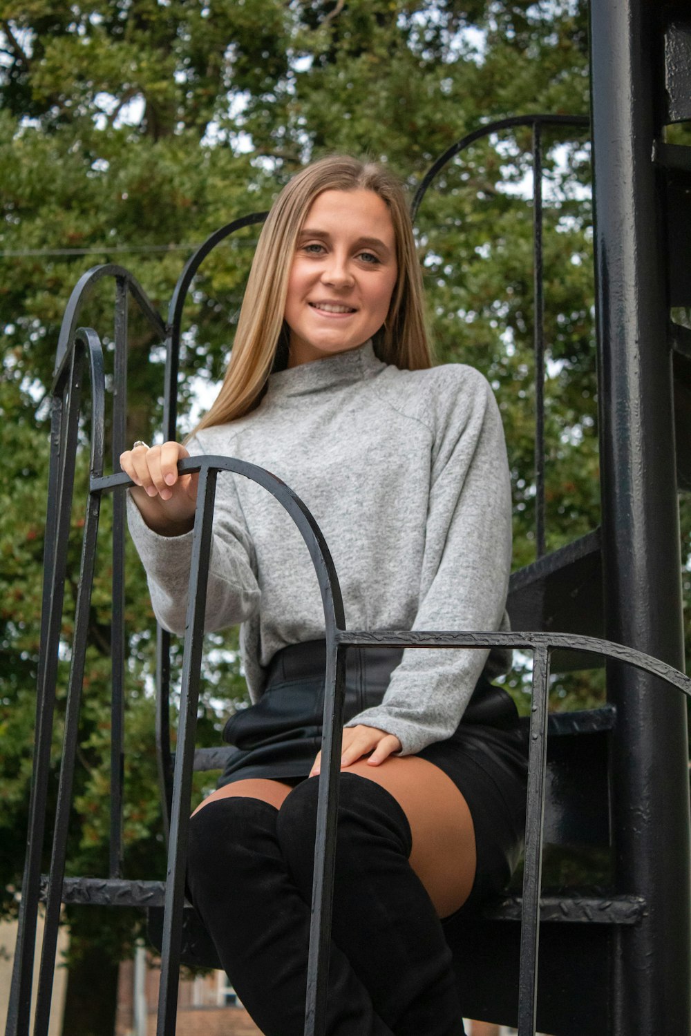 shallow focus photo of woman in gray turtleneck long-sleeved shirt