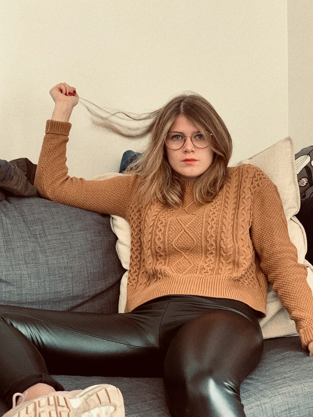 woman sitting on the gray sofa