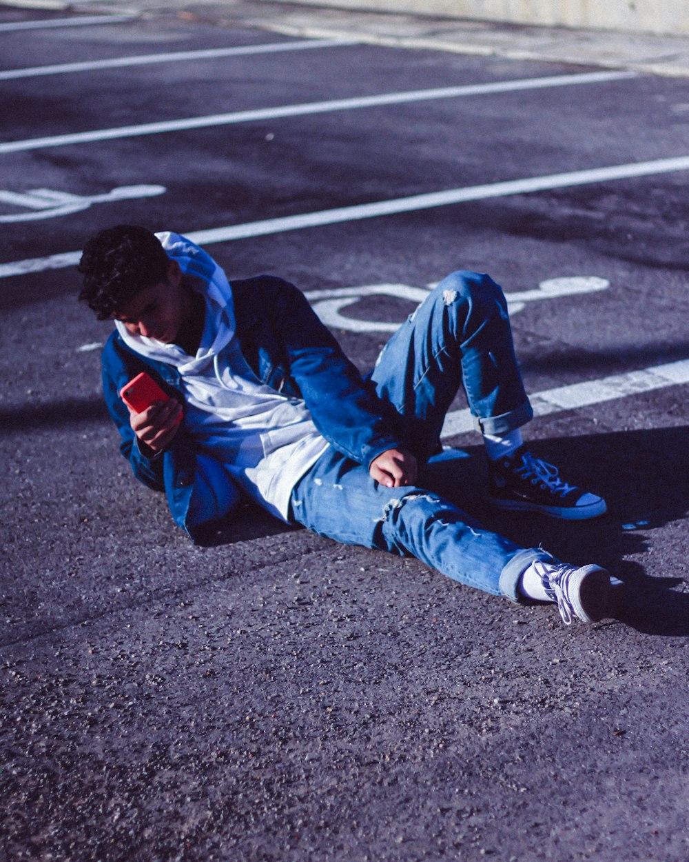 man lying on parking lot