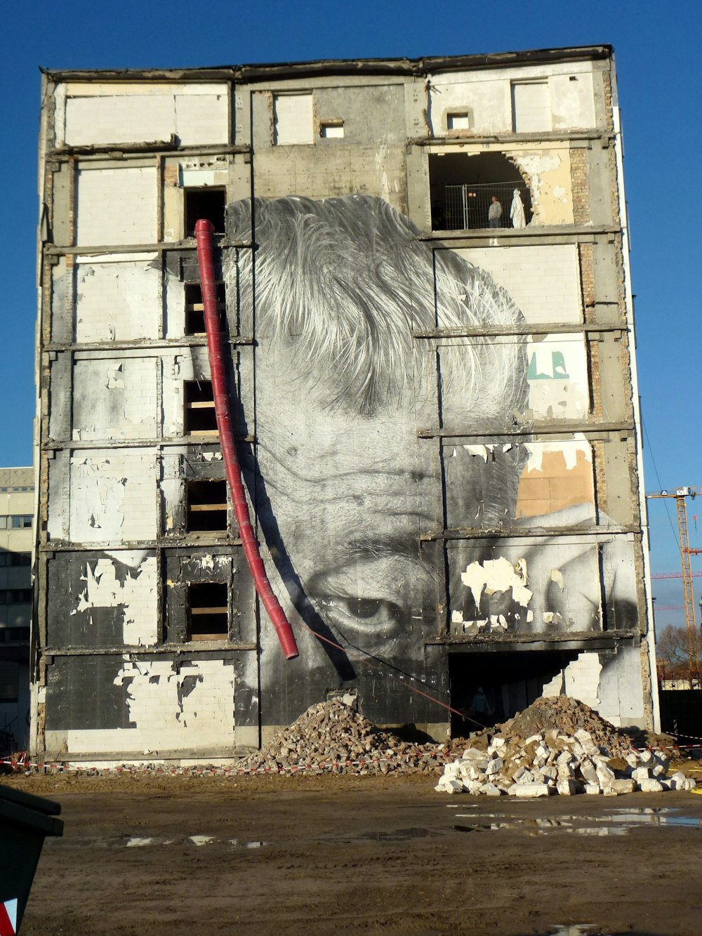 man's portrait on building's wall