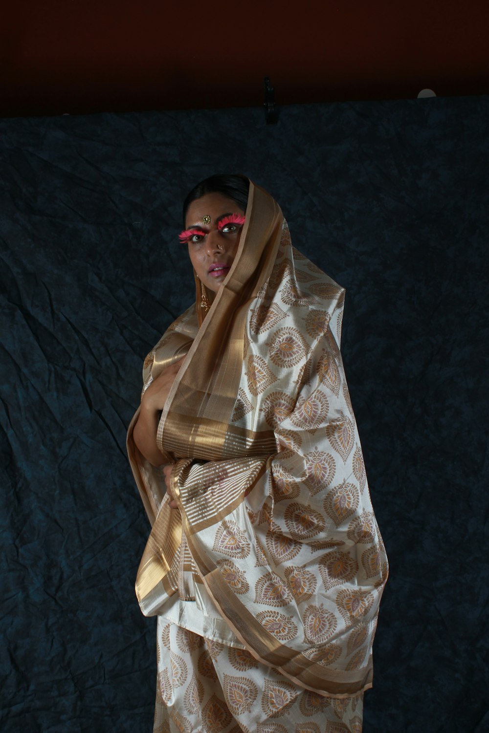 woman covered by brown and gray sari drape