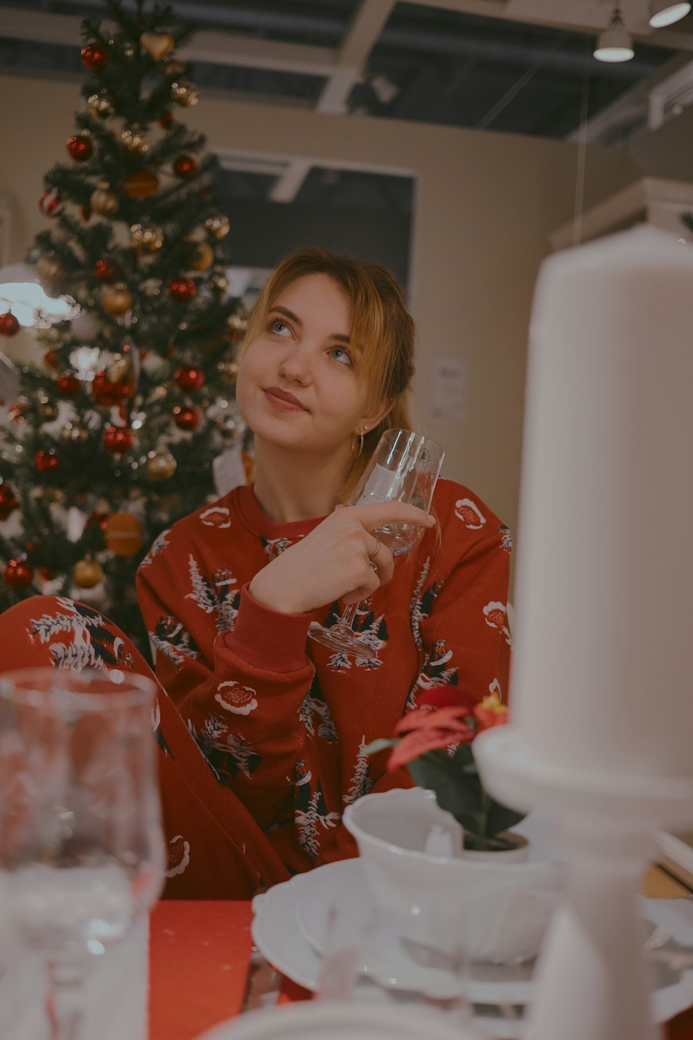 shallow focus photo of woman in red long-sleeved shirt