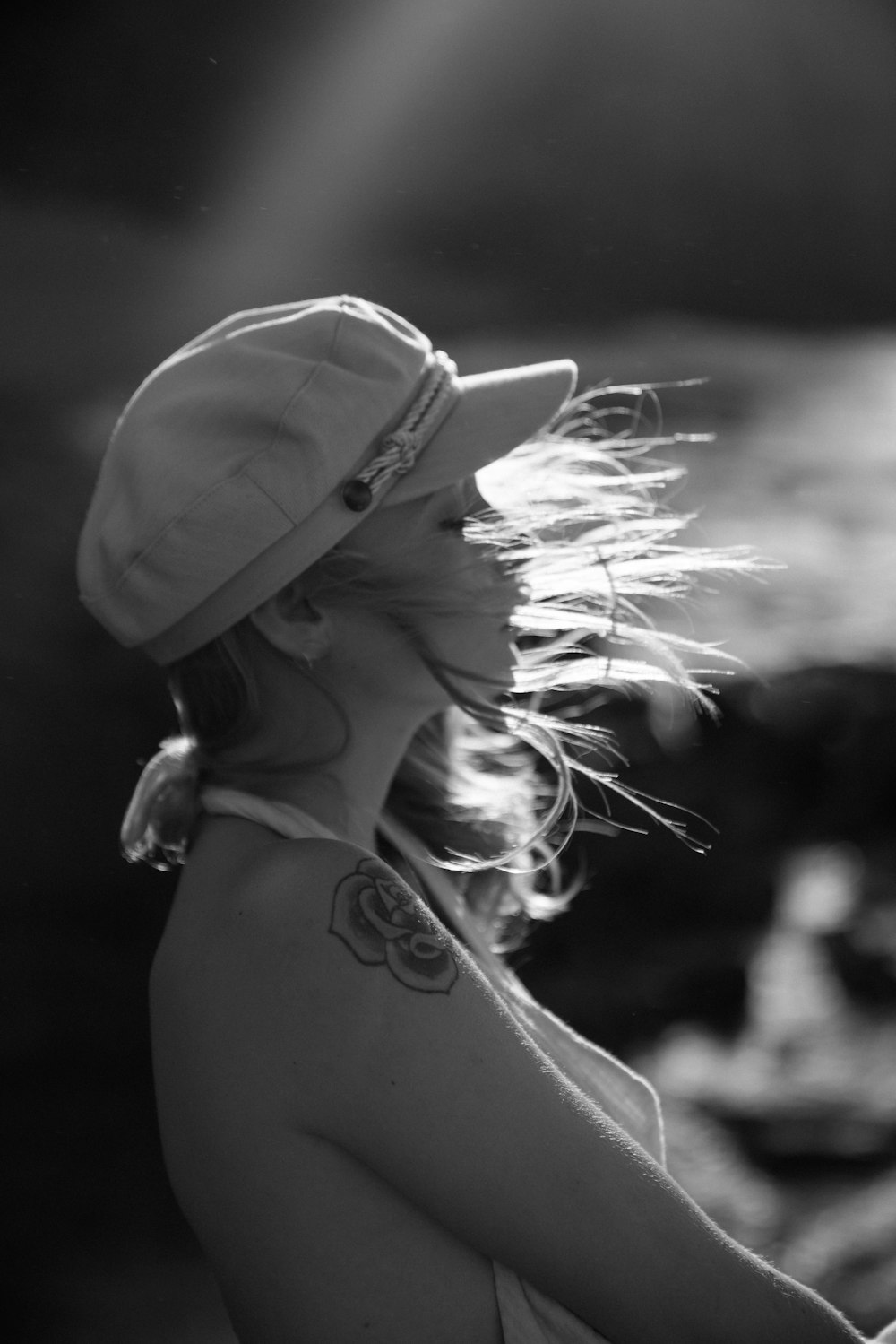 grayscale photo of woman wearing cap