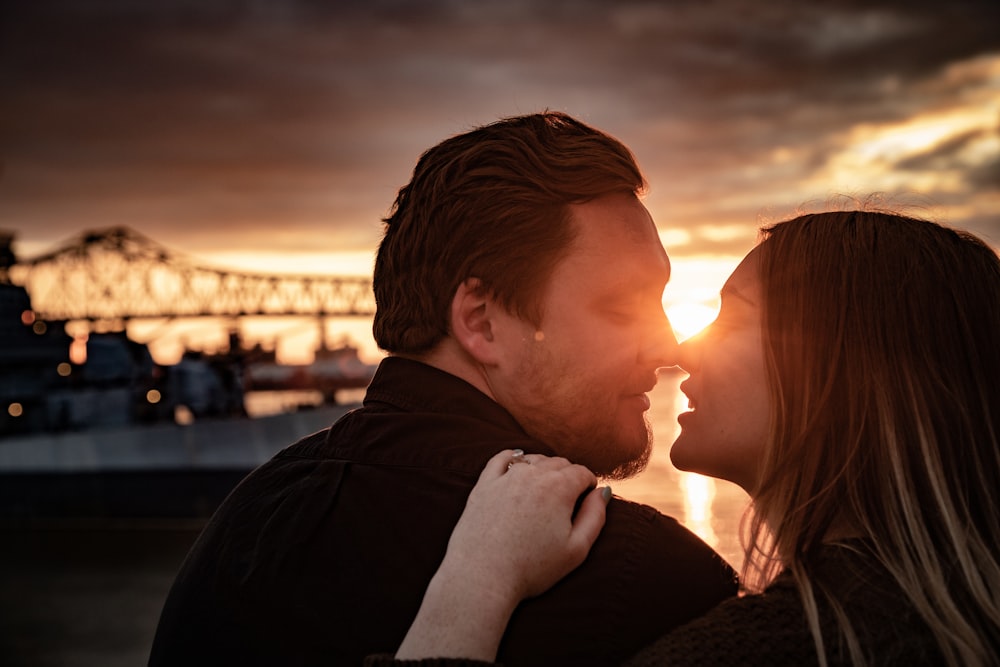 man and woman Eskimo kissing during golden hour