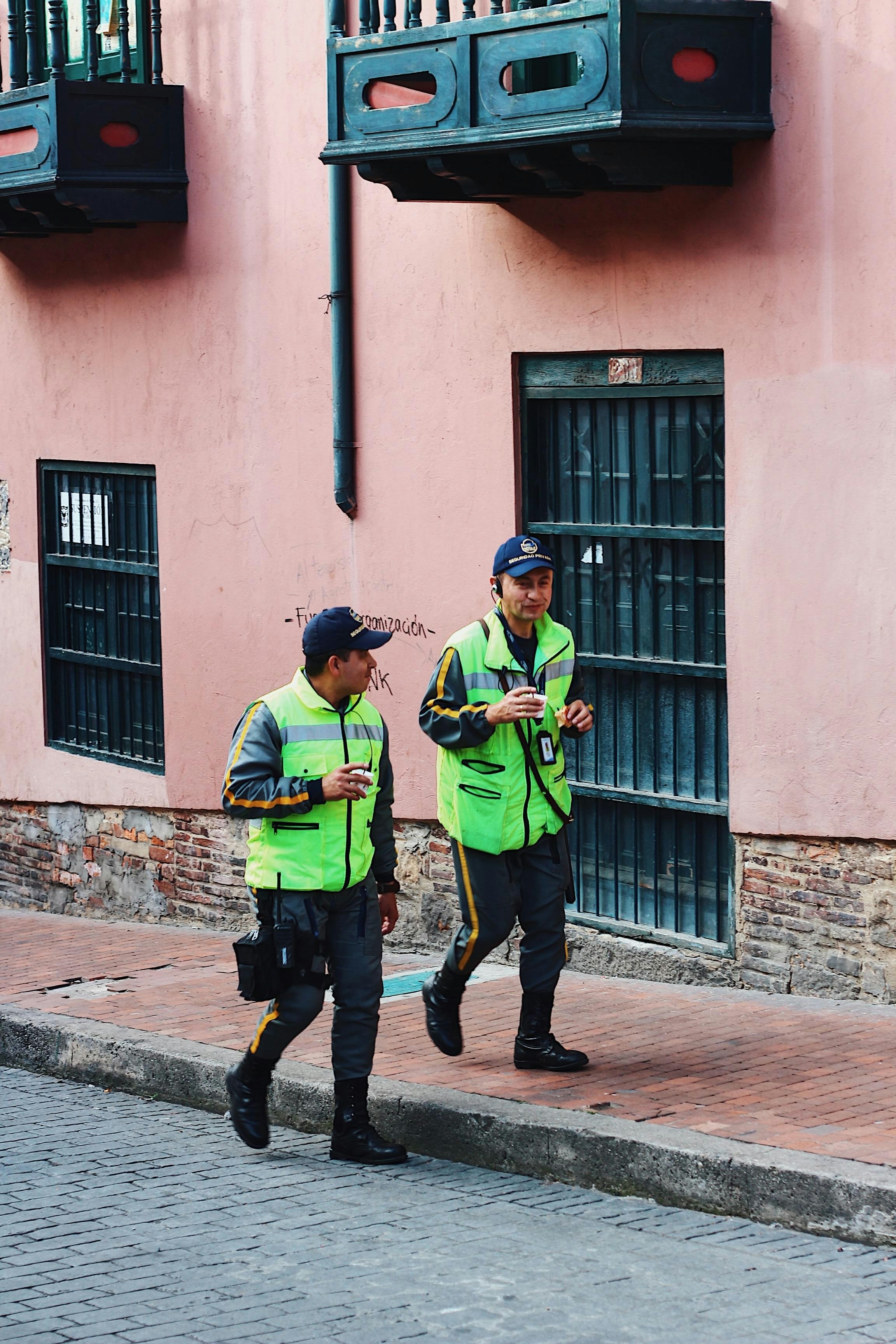 two men walking in street during daytime