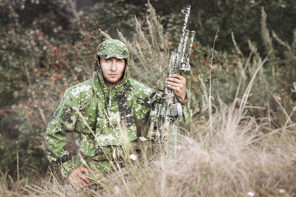 man holding rifle photograph