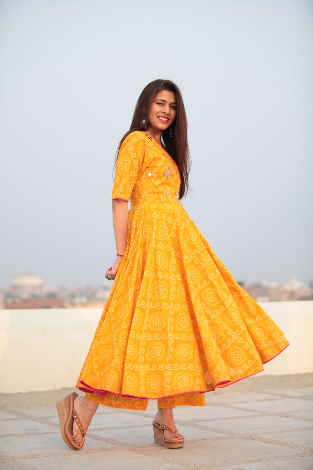 woman smiling and standing on tiled surface