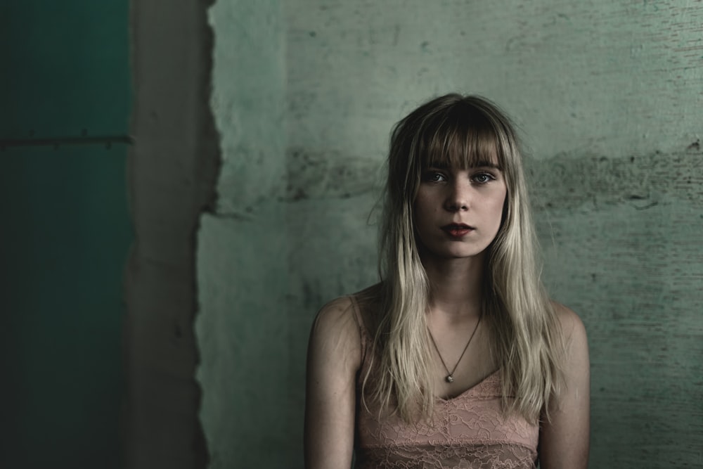 woman with blonde hair near wall