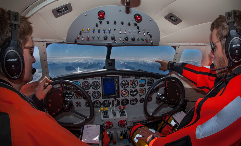 two male pilots inside a cockpit