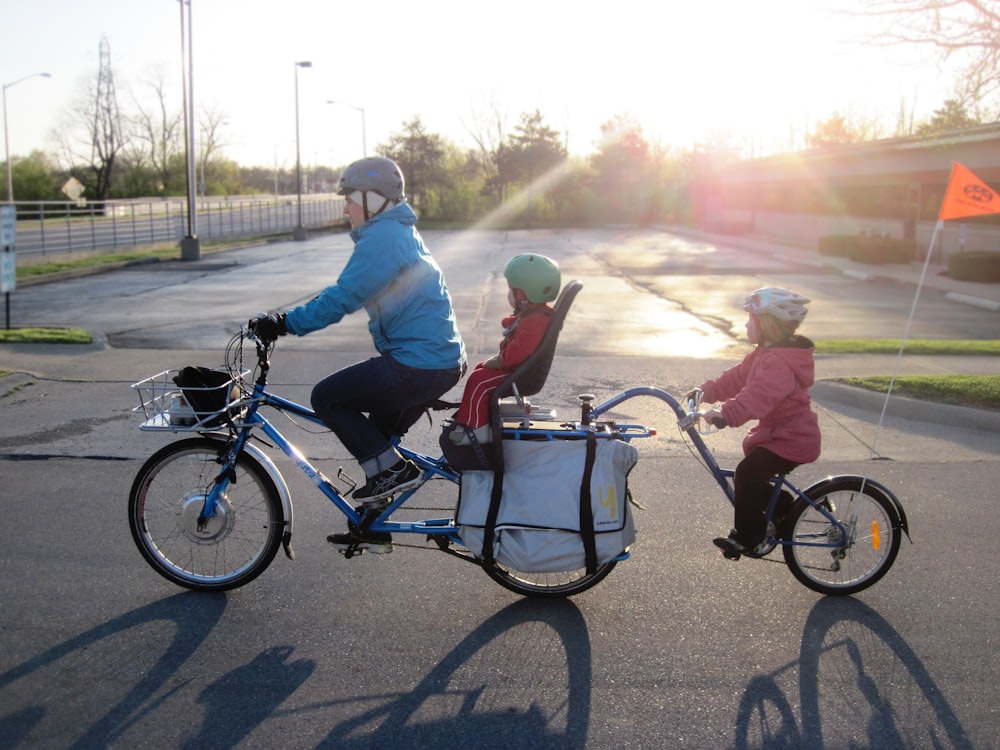 2 men riding on bicycle during daytime