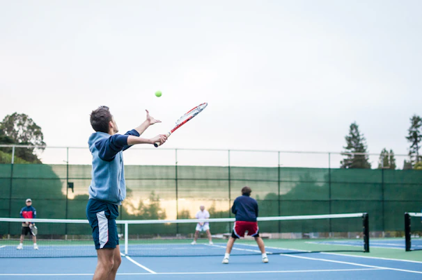Players in mid-action during an intense doubles match, showcasing skill and teamwork.