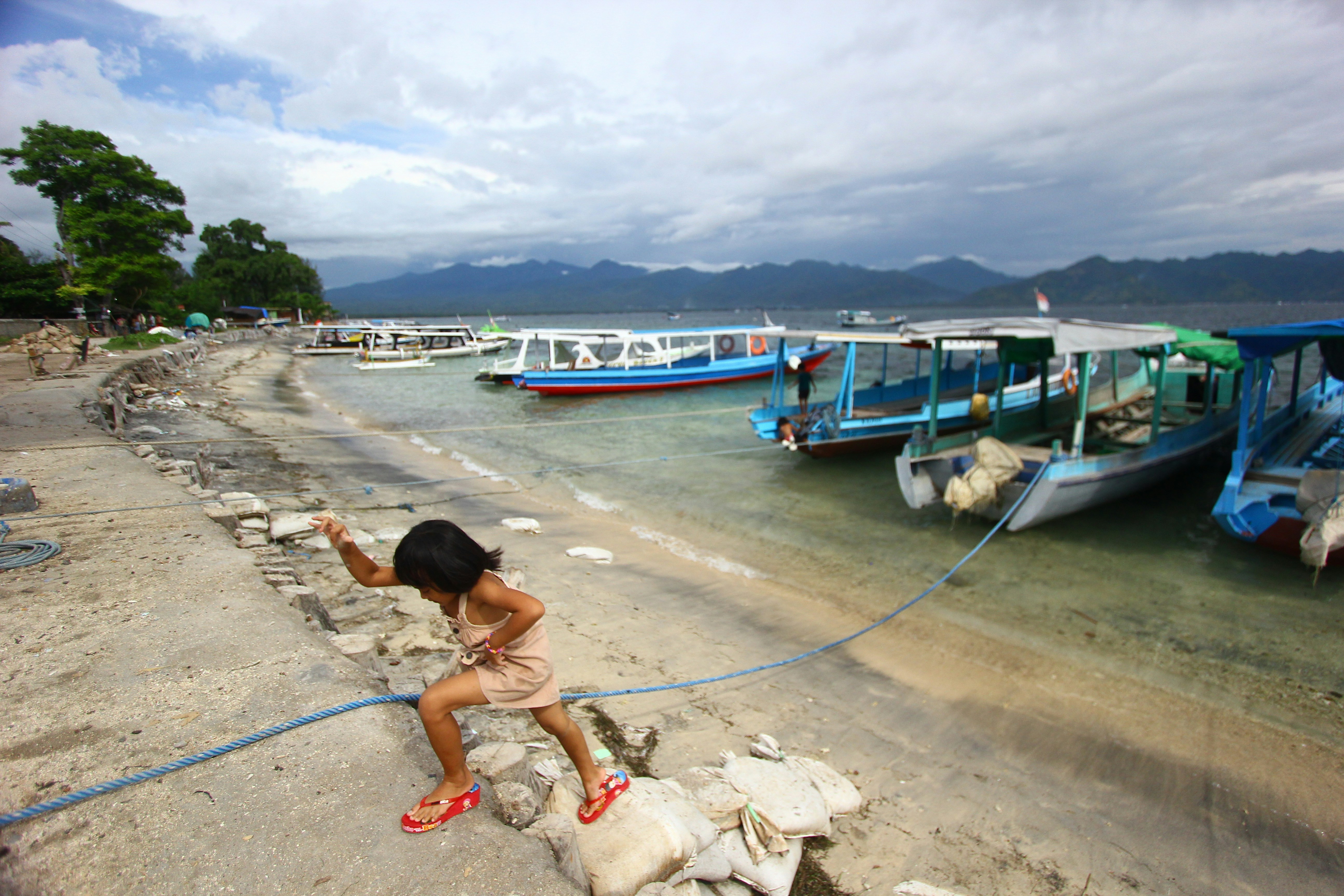 woman walking on dock during daytime