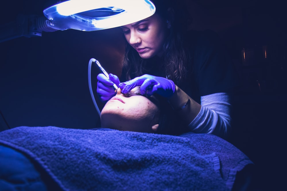 woman fixing another person's face