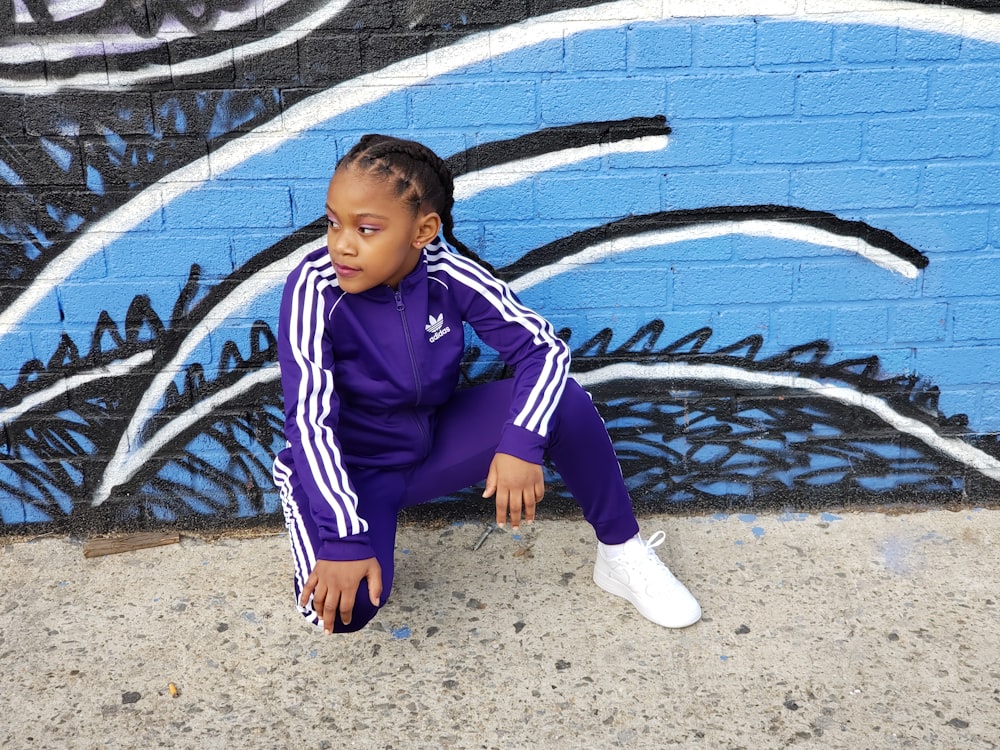 woman wearing purple and white adidas tracksuit