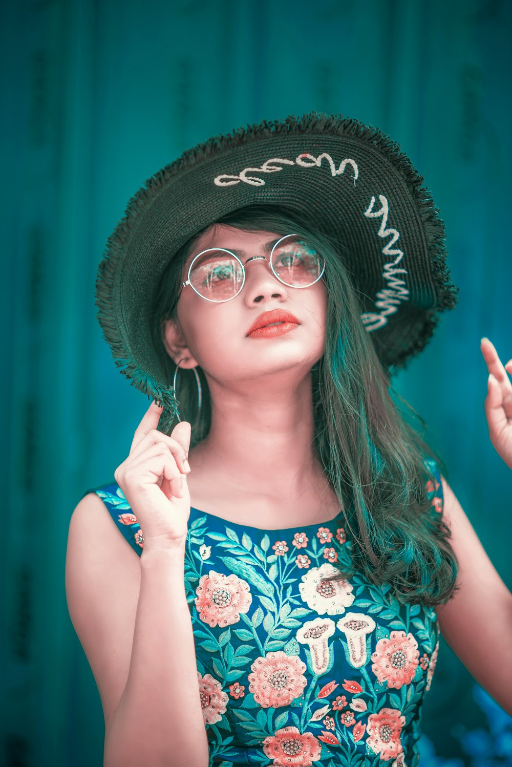 selective focus photography of woman wearing floral dress and black hat