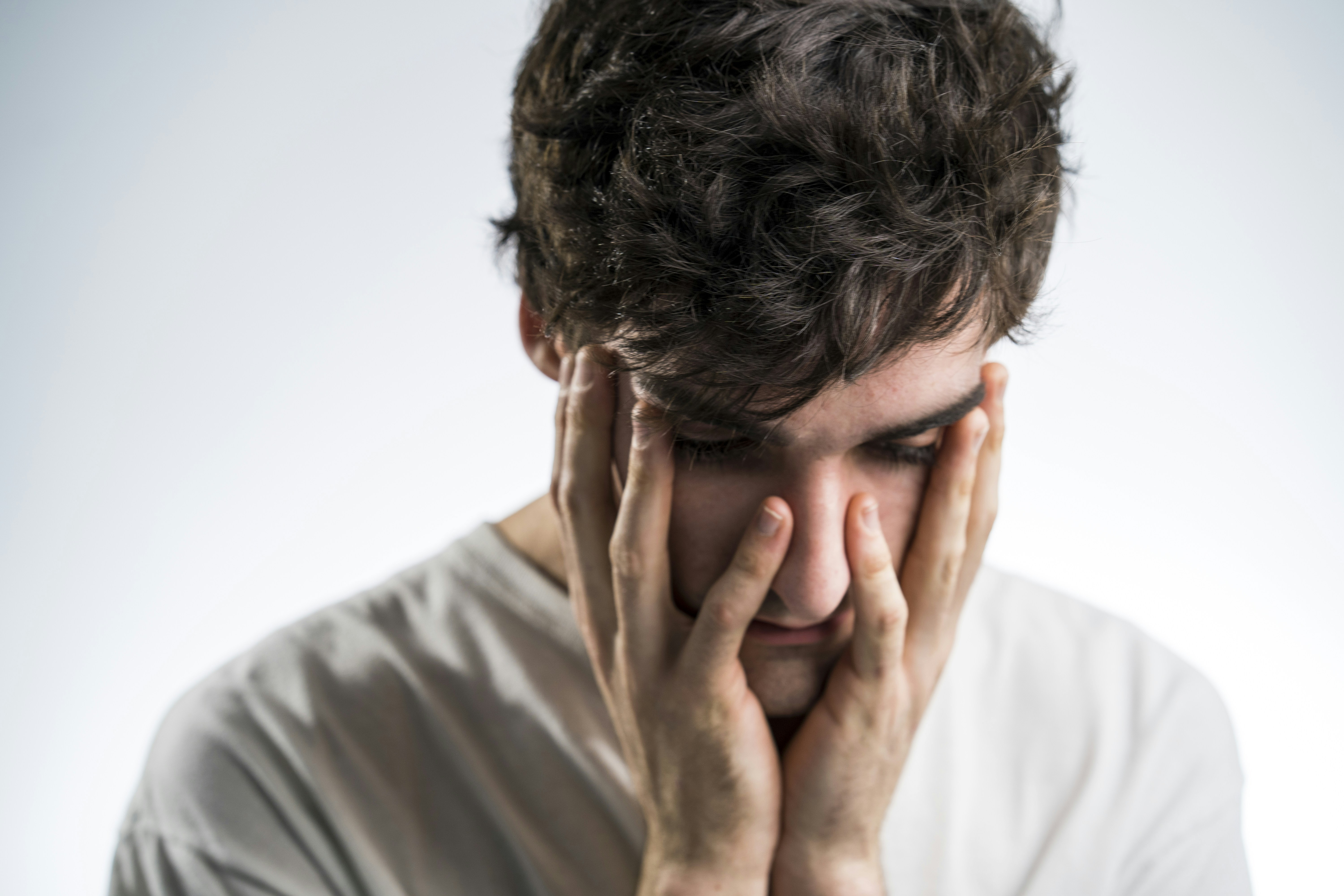 man touching face with both hands