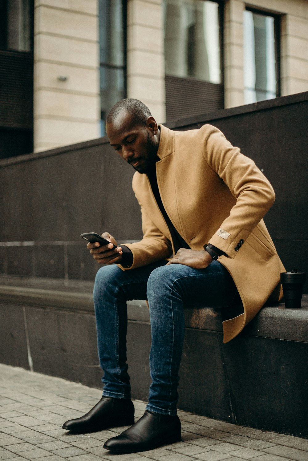 sitting man using smartphone