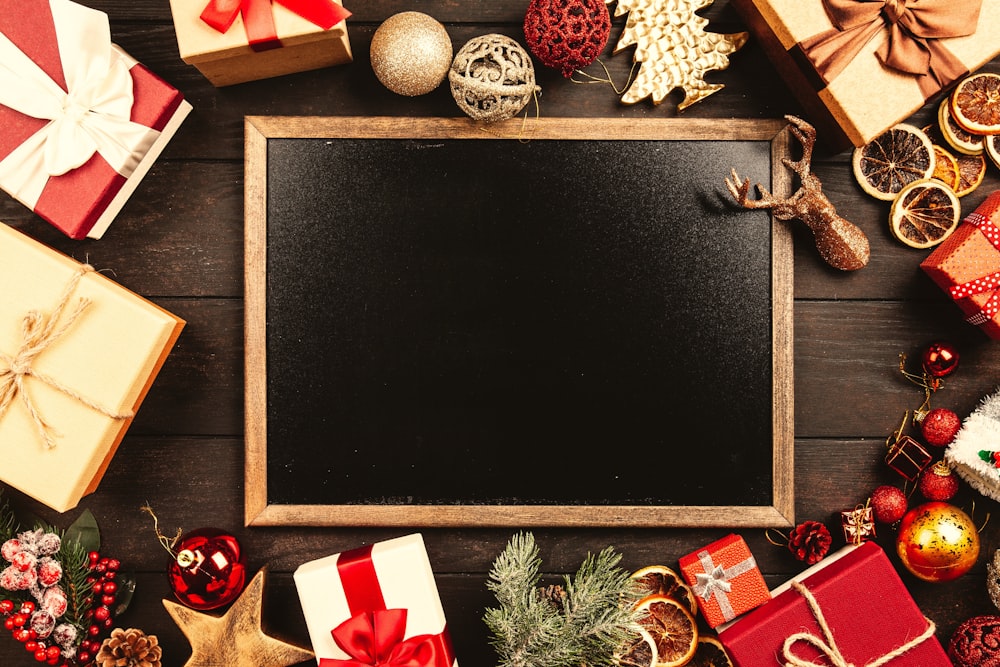 black and brown board surrounded by gift boxes
