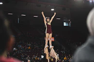 Group of athletes forming a human pyramid during a cheer stunt