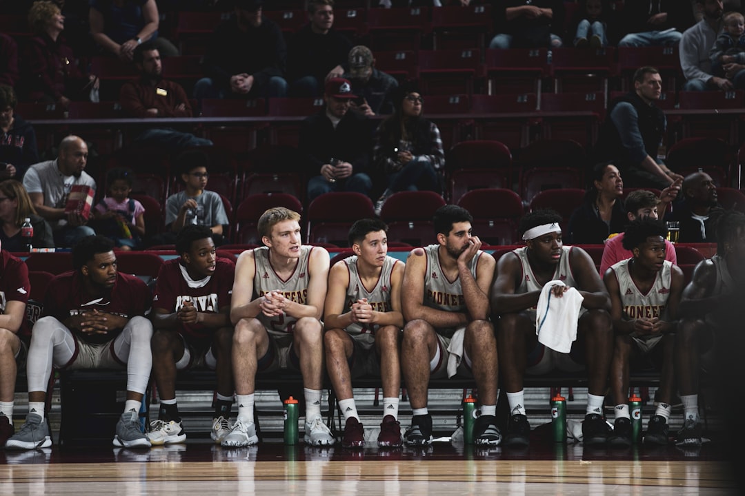 photography of basketball players sitting on bench