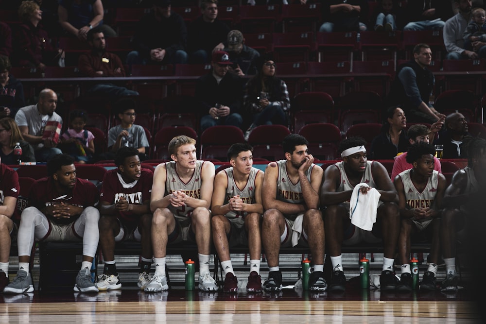 Photography Of Basketball Players Sitting On Bench Photo Free
