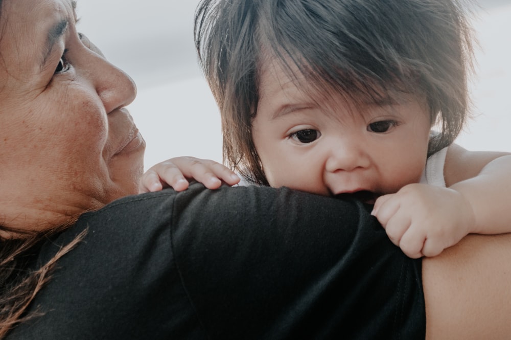 woman carrying toddler