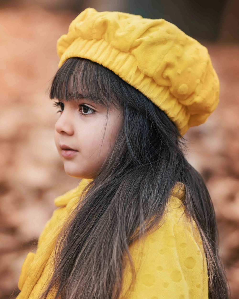 girl wearing yellow hat and yellow dress