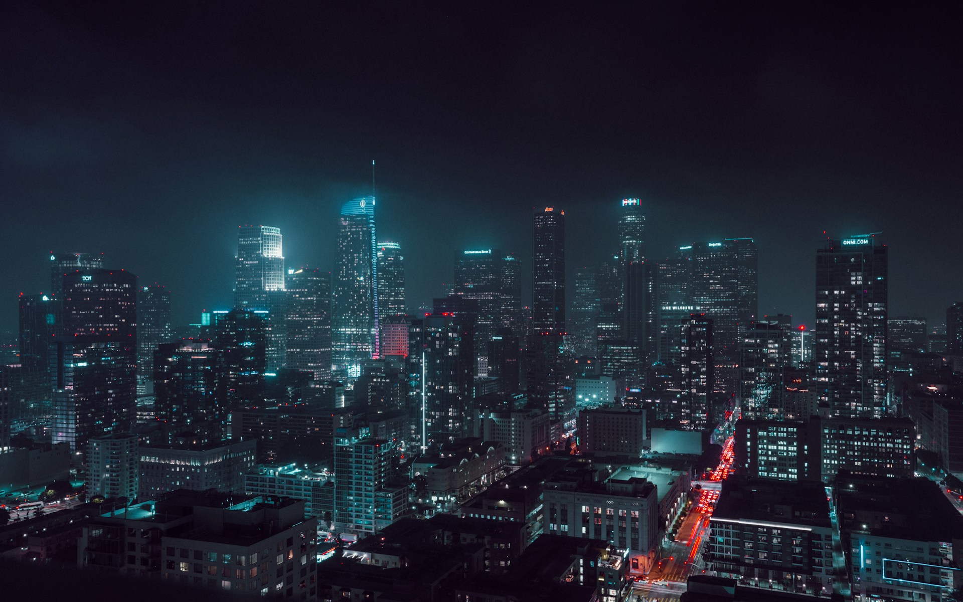 A vibrant animation still showing a sci-fi cityscape with floating vehicles and neon lights against a starry night backdrop.